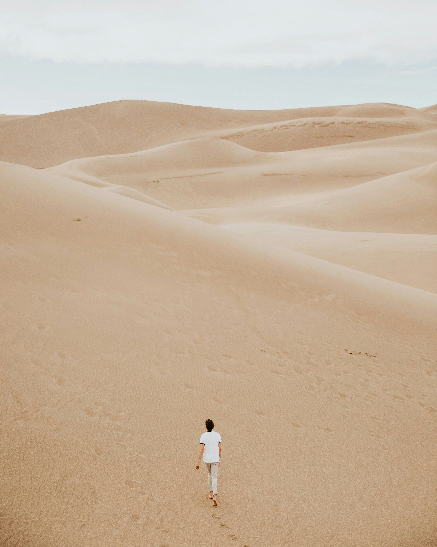 a man walking in desert