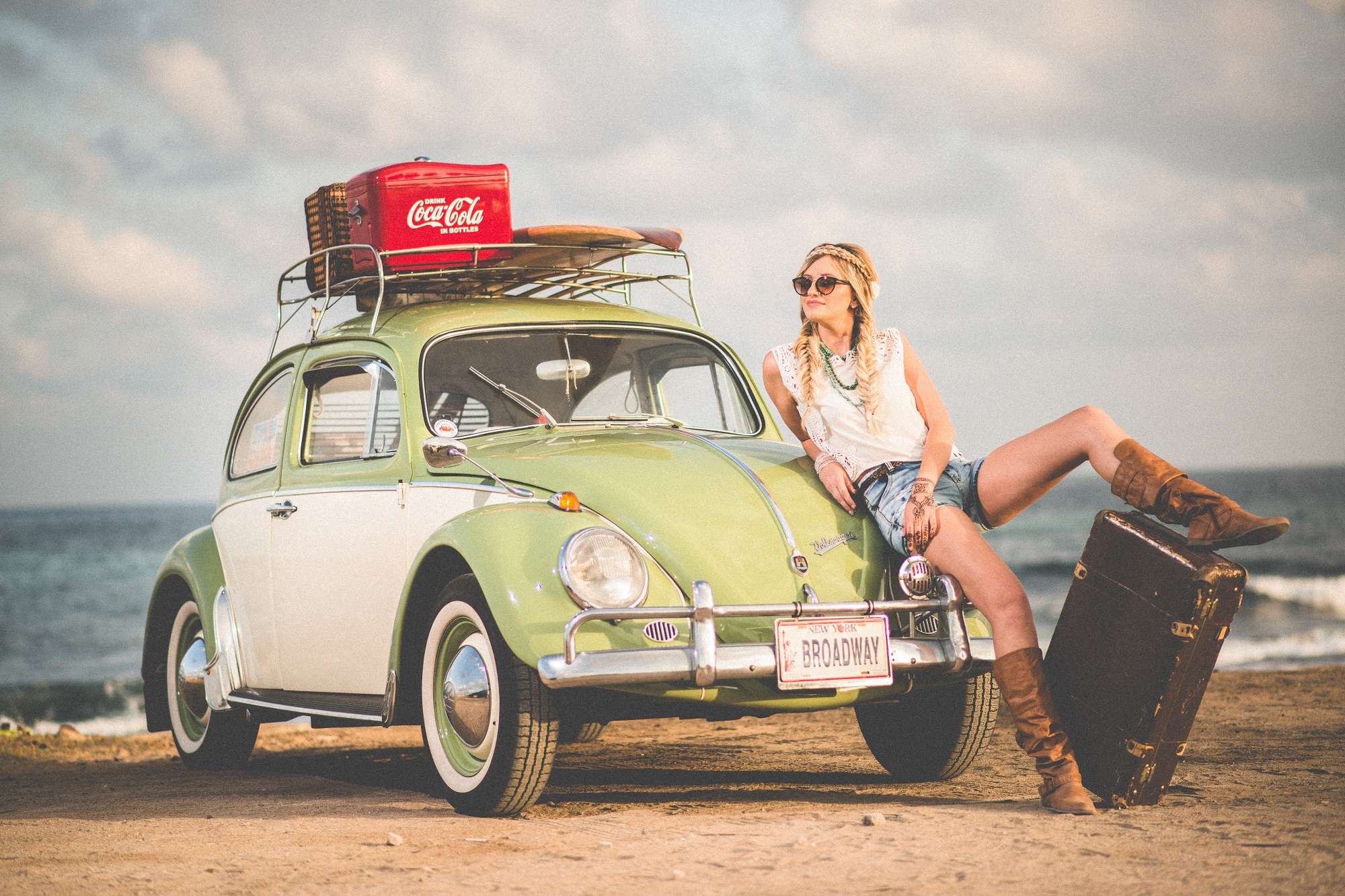 Woman standing with Beetle car